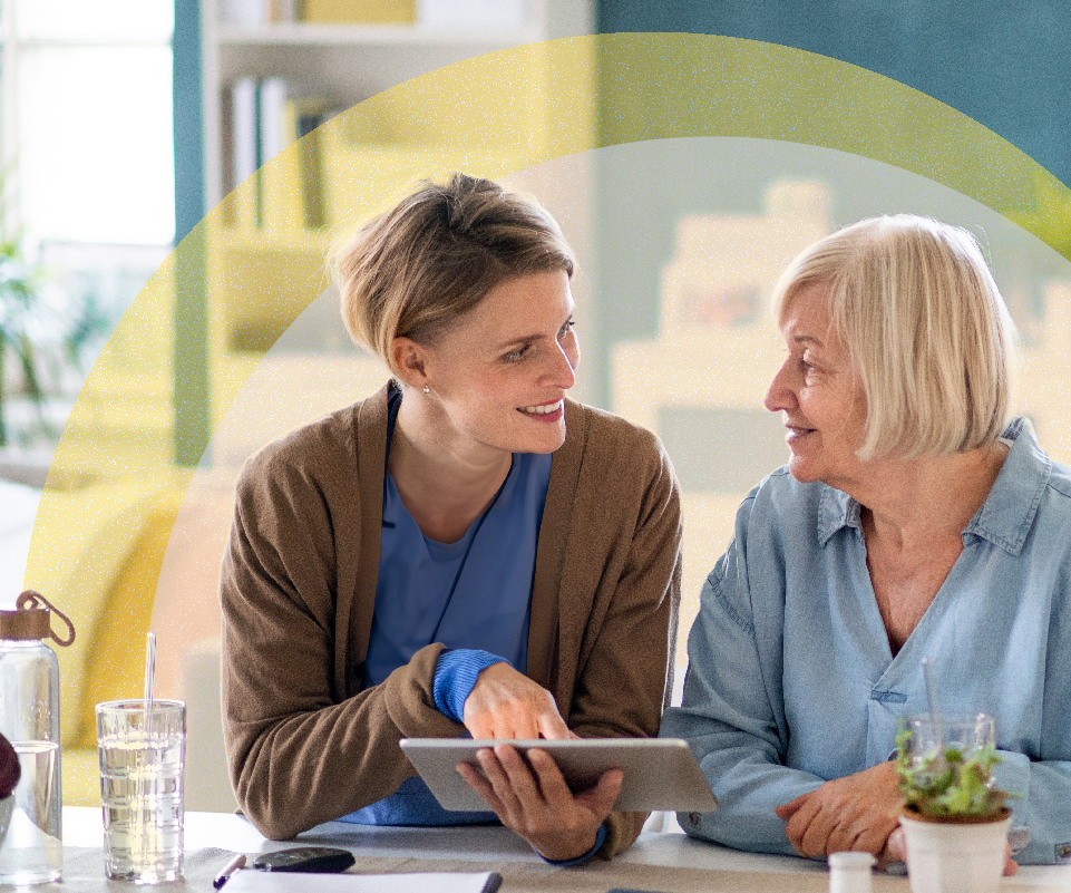 Homecare nurse speaking with female patient at home