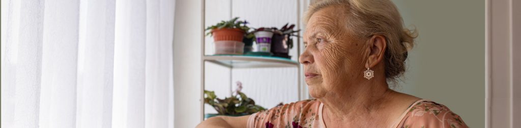 Elderly woman staring out the window