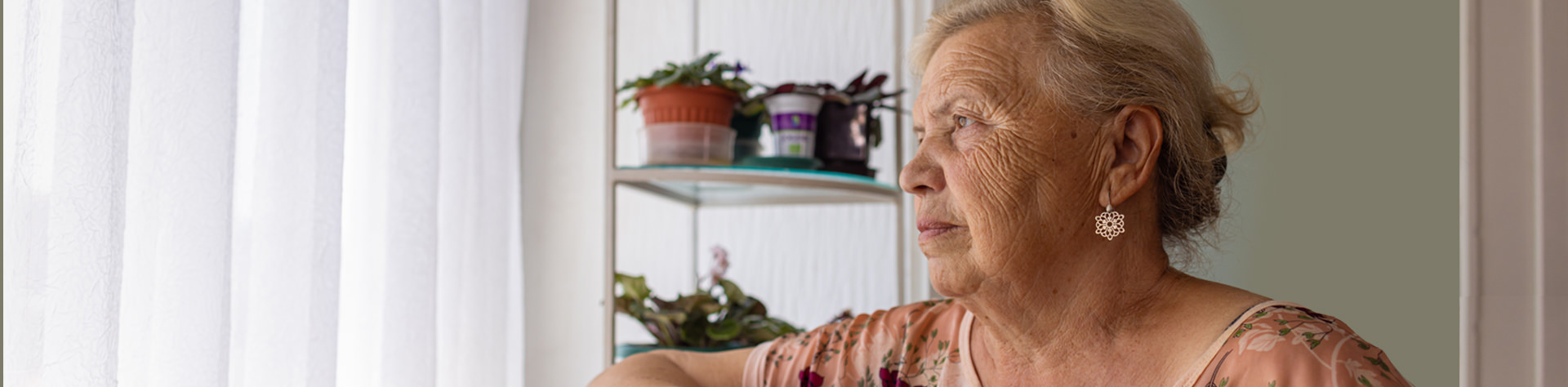 Elderly woman staring out the window